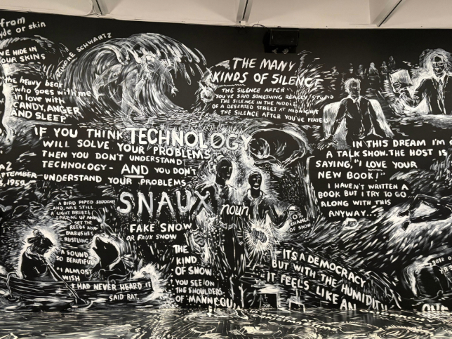 Black-and-white mural filled with expressive illustrations of people talking, with speech bubbles and vibrant colors.